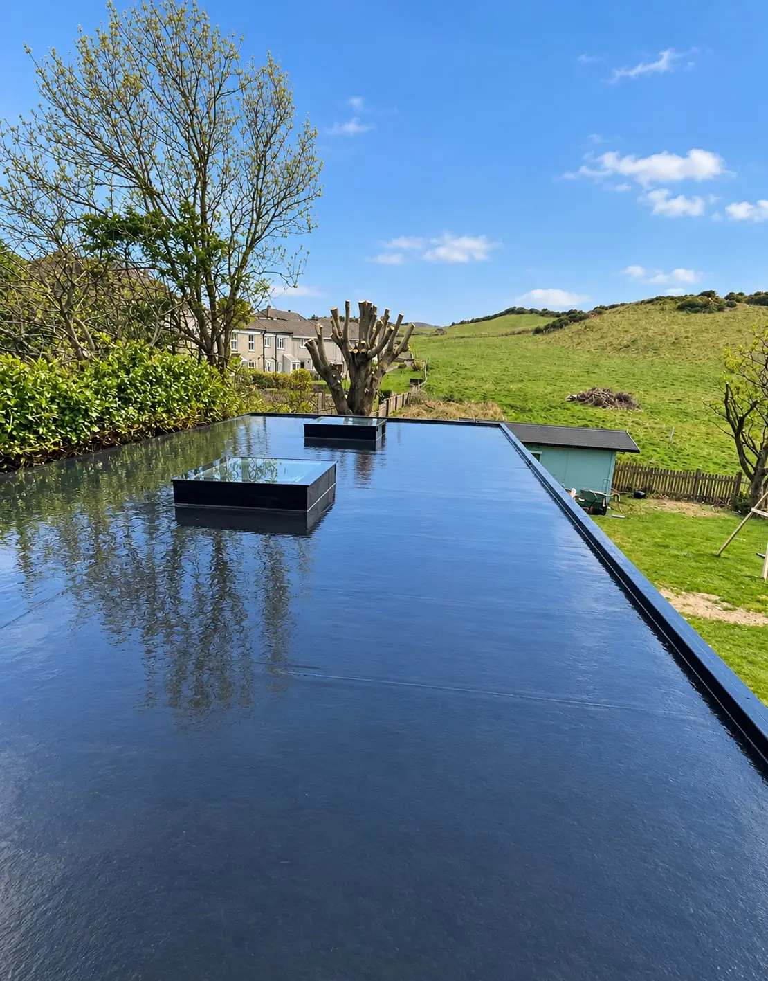 Flat roof with two rooflights, looking out over fields