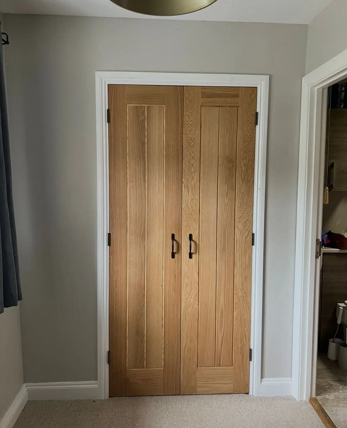 Two oak doors in a white painted frame