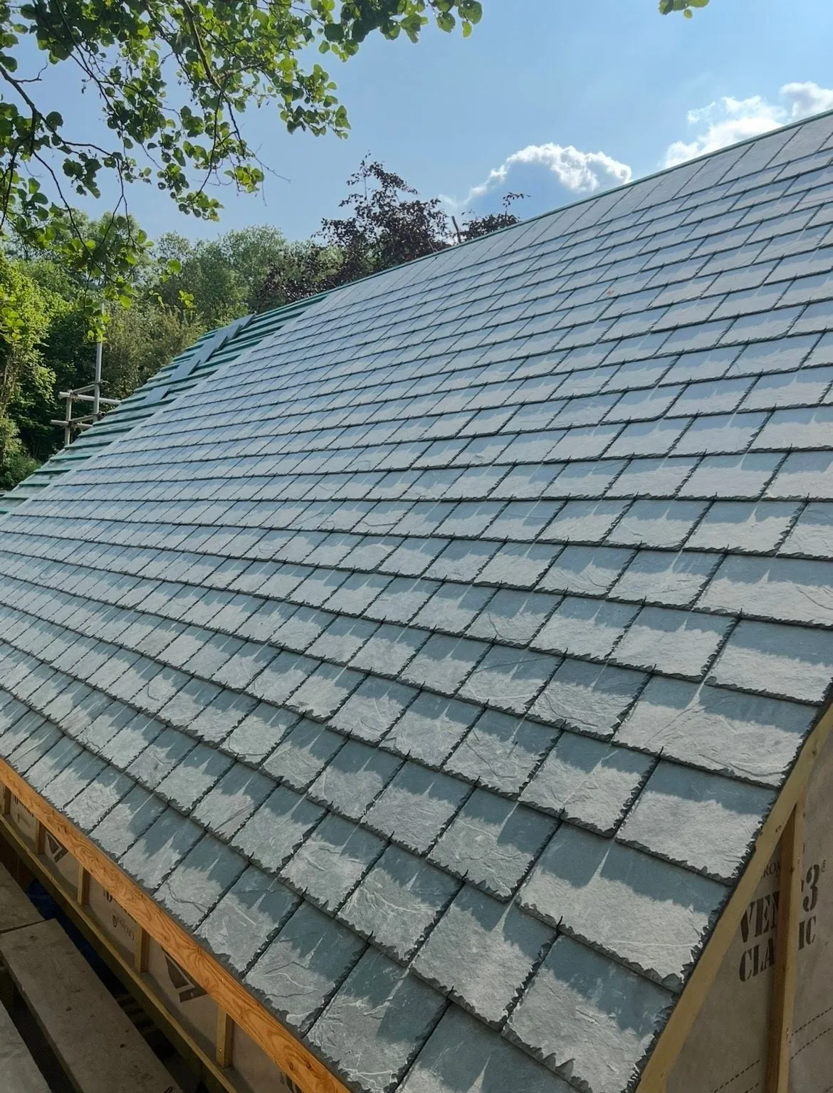 New natural slate roof part way through being laid